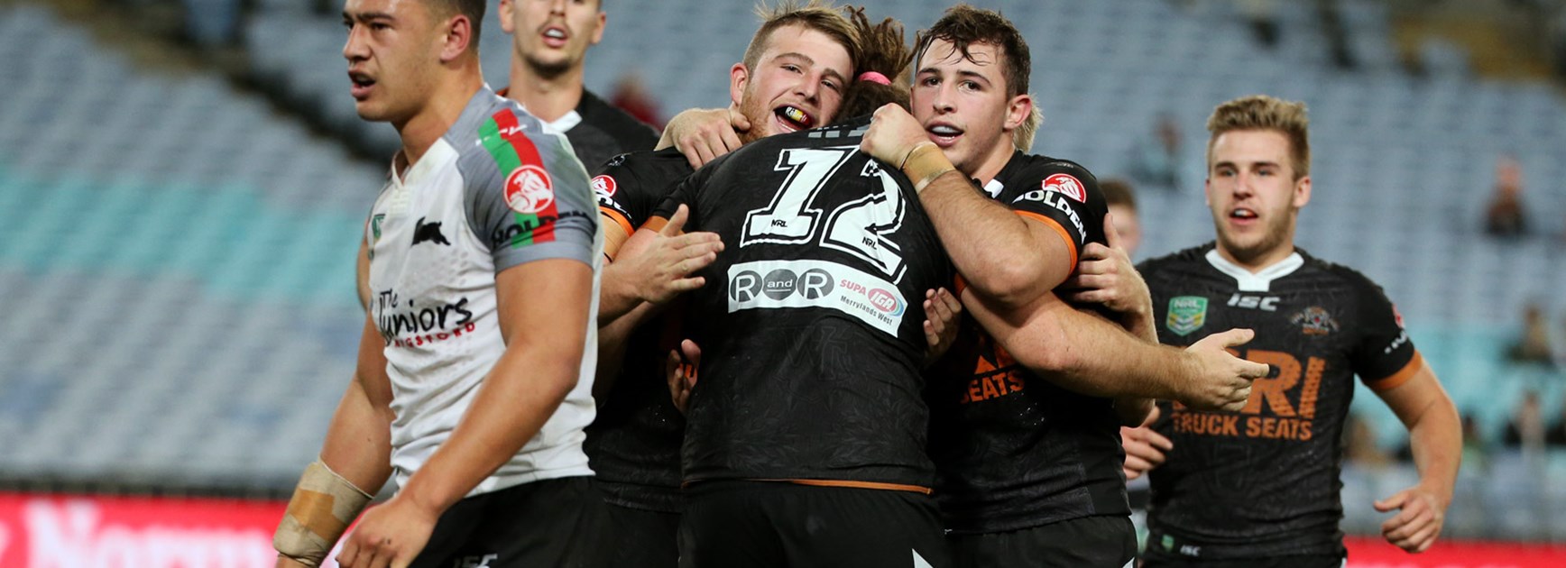 Wests Tigers NYC players celebrate during their win over the Rabbitohs on Friday night.