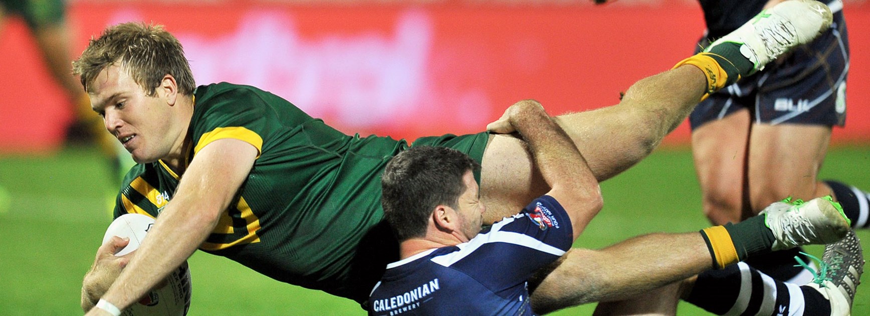 Scotland fullback Lachlan Coote tackles Australia lock Jake Trbojevic in the Four Nations opener.