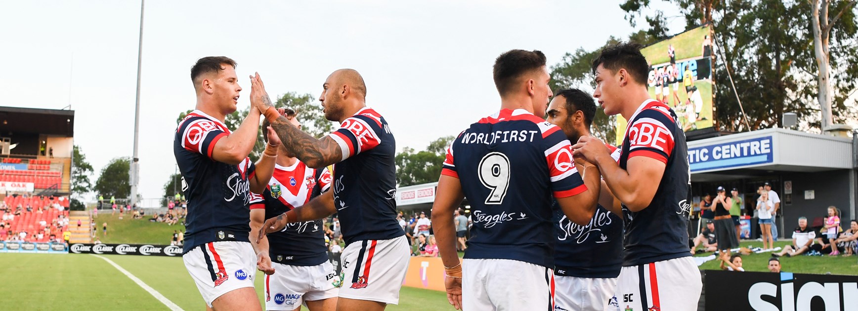 The Roosters celebrate a try against Penrith.