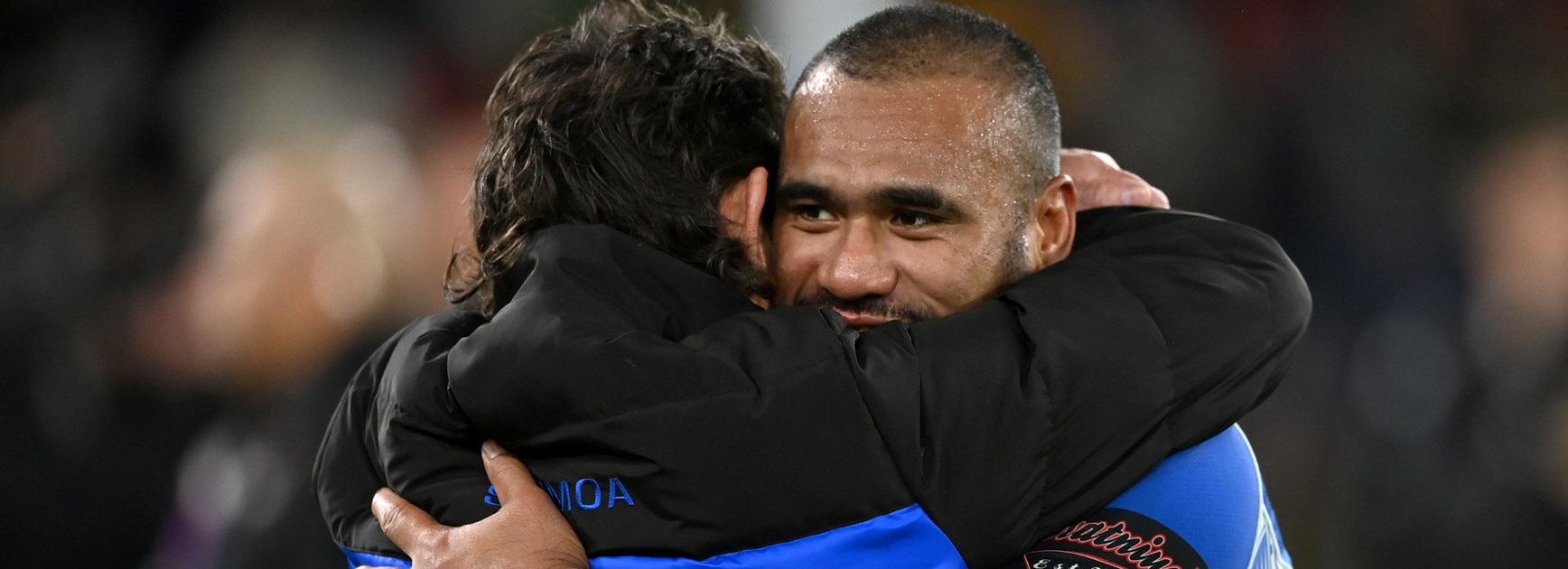 Samoa captain Junior Paulo embraces coach Matt Parish after the World Cup final 