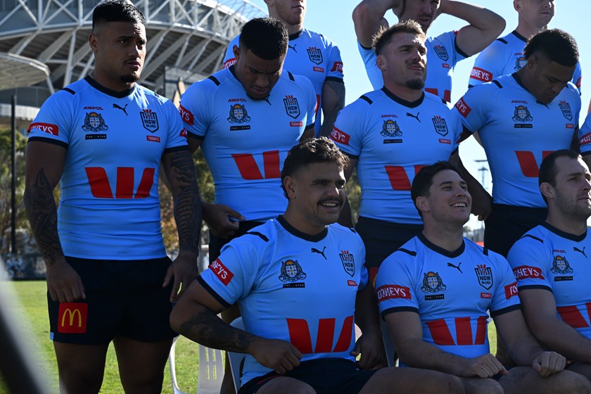 Spencer Leniu and Latrell Mitchell join their Blues teammates for a team photo on Wednesday.