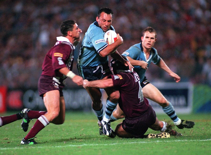 Daley looks to power through the Robbie O’Davis and Darren Smith tackle in 1999. 